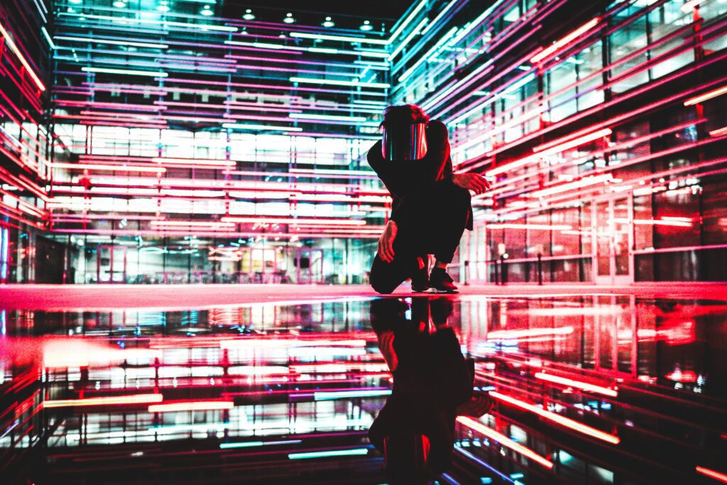Person among red and blue neon lights to represent metaverse real estate